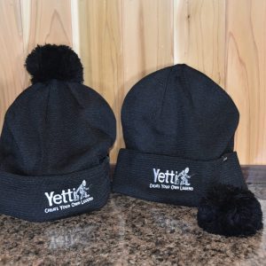 Black Yetti Fish House branded hats with fluffy pom poms.