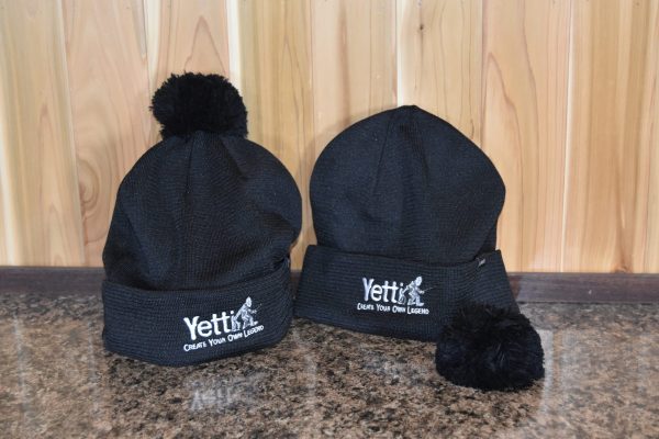 Black Yetti Fish House branded hats with fluffy pom poms.